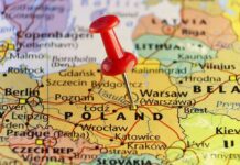 Border Breach Sparks NATO Panic Red pushpin marking Poland on a European map