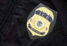 ICE officer badge on a dark uniform