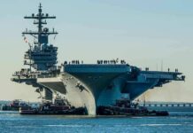 Toxic Warship Dumped—What’s Brazil Hiding? Aircraft carrier guided by tugboats in a harbor