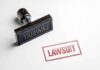 Rubber stamp with red lawsuit imprint on white paper