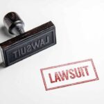 Rubber stamp with red lawsuit imprint on white paper