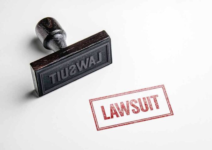 shutterstock_1019053363 Rubber stamp with red lawsuit imprint on white paper