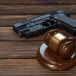 Tax Trick Blows Up 90-Year Gun Rule Gavel and handgun on wooden table