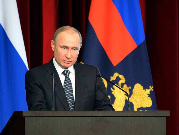 man in suit speaking at a podium