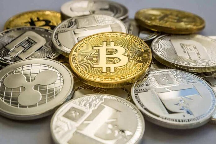 shutterstock_1132017965 Stack of assorted cryptocurrency coins with a gold bitcoin in the center