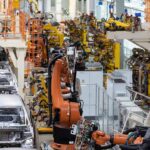 Industrial robots assemble car bodies on an automotive production line