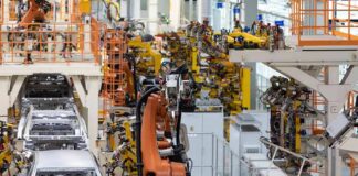 Industrial robots assemble car bodies on an automotive production line