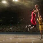 Two basketball players contest a layup under the hoop
