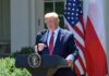 man at presidential podium speaking outdoors