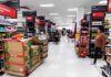 Hobby Lobby Bathroom Ritual Sparks Fury Interior of a grocery store with shelves filled with products and shoppers