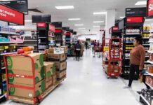 Hobby Lobby Bathroom Ritual Sparks Fury Interior of a grocery store with shelves filled with products and shoppers