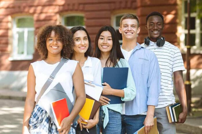 shutterstock_1757465525 Group of students standing outside a campus building