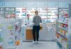 Customer at pharmacy counter speaking with pharmacist
