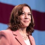 Election Crackdown Sparks Backlash woman speaking at podium with flag backdrop