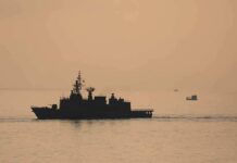 Iran Blinks? Surprise Hormuz Deal Brewing naval ship silhouette at sea during sunset