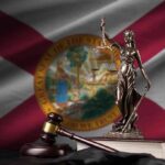 Judge Greenlights Explosive Abortion Fight Lady Justice statue with gavel and book before Florida state flag