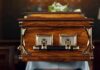 Freemason Funeral Sparks Macron Uproar wooden coffin with brass handles in a church