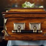 wooden coffin with brass handles in a church