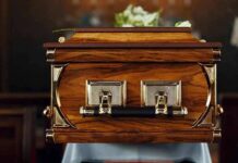 Freemason Funeral Sparks Macron Uproar wooden coffin with brass handles in a church