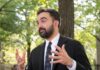 Teacher Endorsement Explodes — City Hall Meltdown Man in a suit gesturing while speaking outdoors