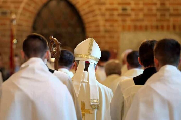 Bishop in white mitre among clergy during church procession