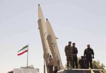 Iran’s War Reset Stuns Washington soldiers stand beside large missiles at outdoor display