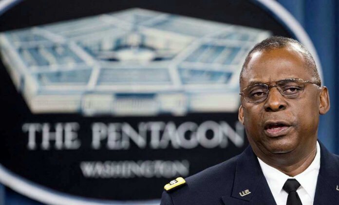 2027618987 Lloyd Austin speaking at a podium in front of a Pentagon emblem