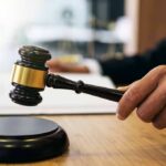 Court Bombshell Upends Oregon Adoption Rule Judge's hand holding a gavel over a sound block