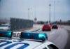 Police Restraint Backfires? Portland On Edge Police car with blue lights on near a roadway