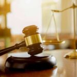 Warrantless Raids Halted – DHS On Notice Judge's gavel on a block with scales of justice in the background