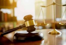 Warrantless Raids Halted – DHS On Notice Judge's gavel on a block with scales of justice in the background
