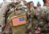 Major Incident Triggers Village Evacuation U.S. flag patch on a camouflage military uniform
