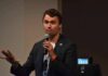 Immunity Shield Looms After Campus Killing man speaking into a microphone during a talk