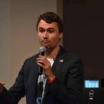 Immunity Shield Looms After Campus Killing man speaking into a microphone during a talk