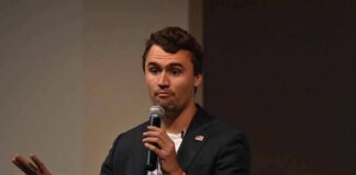 man speaking into a microphone during a talk