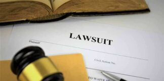 Lawsuit documents with gavel, pen, and legal book