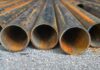 Trump’s $15B Steel Plant Gamble Shakes Iowa Rusty metal pipes laid on gravel