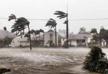 Houses battered by hurricane winds and flooding
