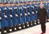 Silent Troop Surge – What’s Moscow Planning? Vladimir Putin walks past an honor guard; Genaro García Luna and Darius Kilgo not visible