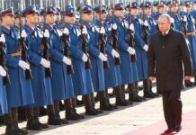 Silent Troop Surge – What’s Moscow Planning? Vladimir Putin walks past an honor guard; Genaro García Luna and Darius Kilgo not visible