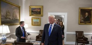 Donald Trump walks through an office with Sean Lawler nearby and Mariano Rajoy following behind