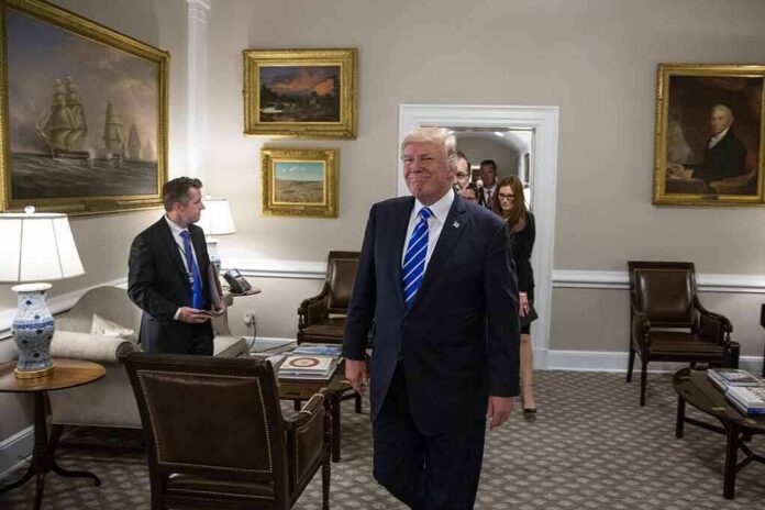 shutterstock_1456093772 Donald Trump walks through an office with Sean Lawler nearby and Mariano Rajoy following behind