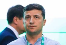 Ceasefire Offer Hinges On Power Grids man with short dark hair wearing a lanyard