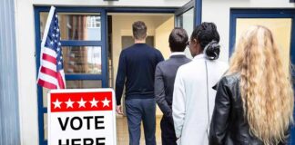 Voters standing in line at a polling place entrance