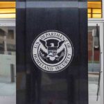 U.S. Department of Homeland Security emblem on building entrance