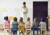 Teacher reading to children seated in a classroom