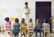 Teacher reading to children seated in a classroom