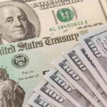 U.S. Treasury check and hundred-dollar bills
