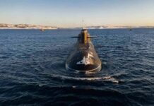 Cabinet Bottleneck Freezes $8B Subs Submarine cruising on cold open water toward camera