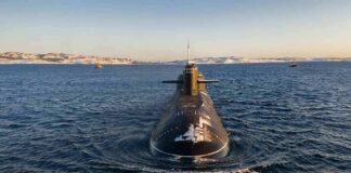 Submarine cruising on cold open water toward camera